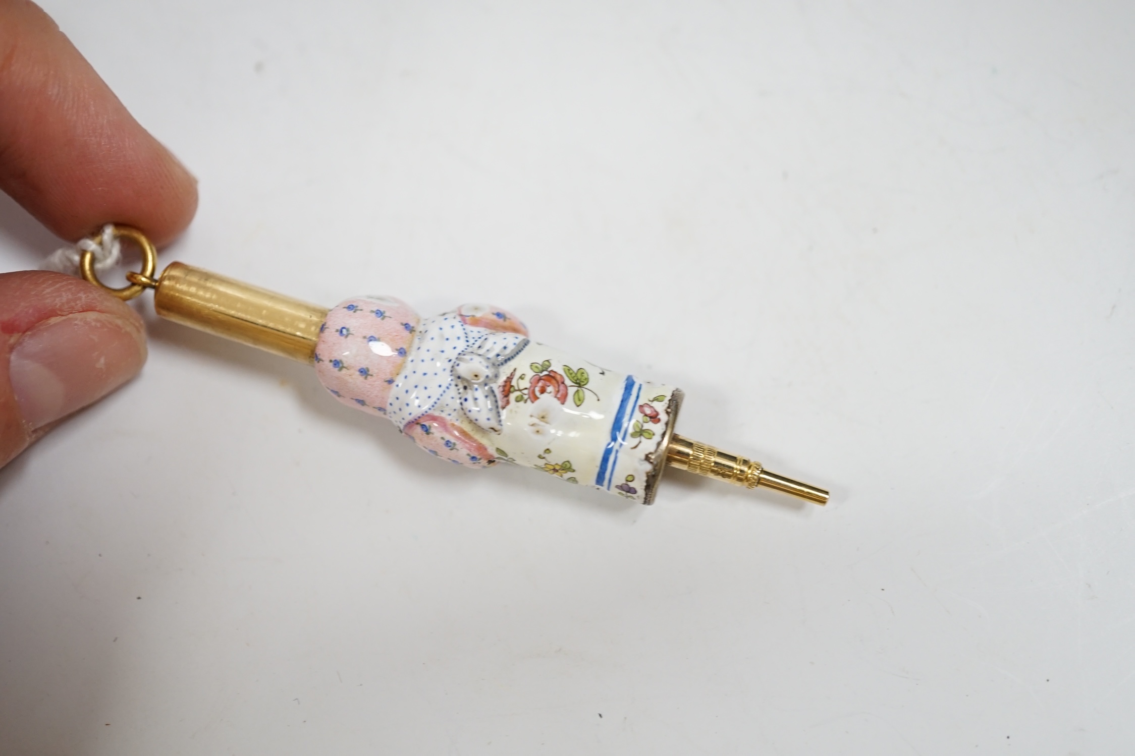 A rare Asprey and Son gilt metal and enamel novelty propelling pencil, c.1875, modelled as an infant holding a rattle. Condition - fair, losses to enamel